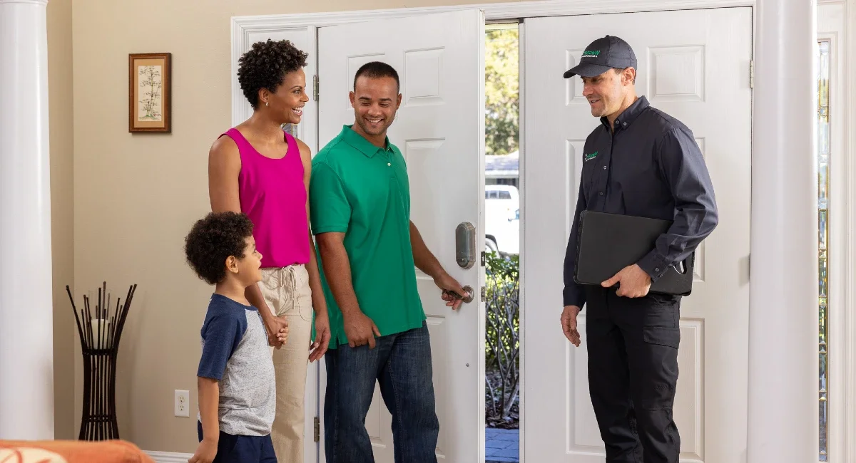 Professional discussing fly control service value with homeowner